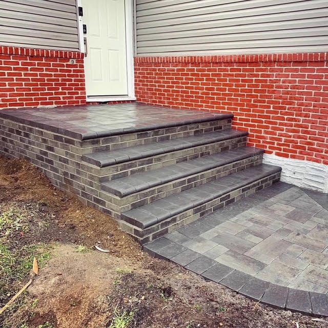 New paver front steps with charcoal treads and tan risers