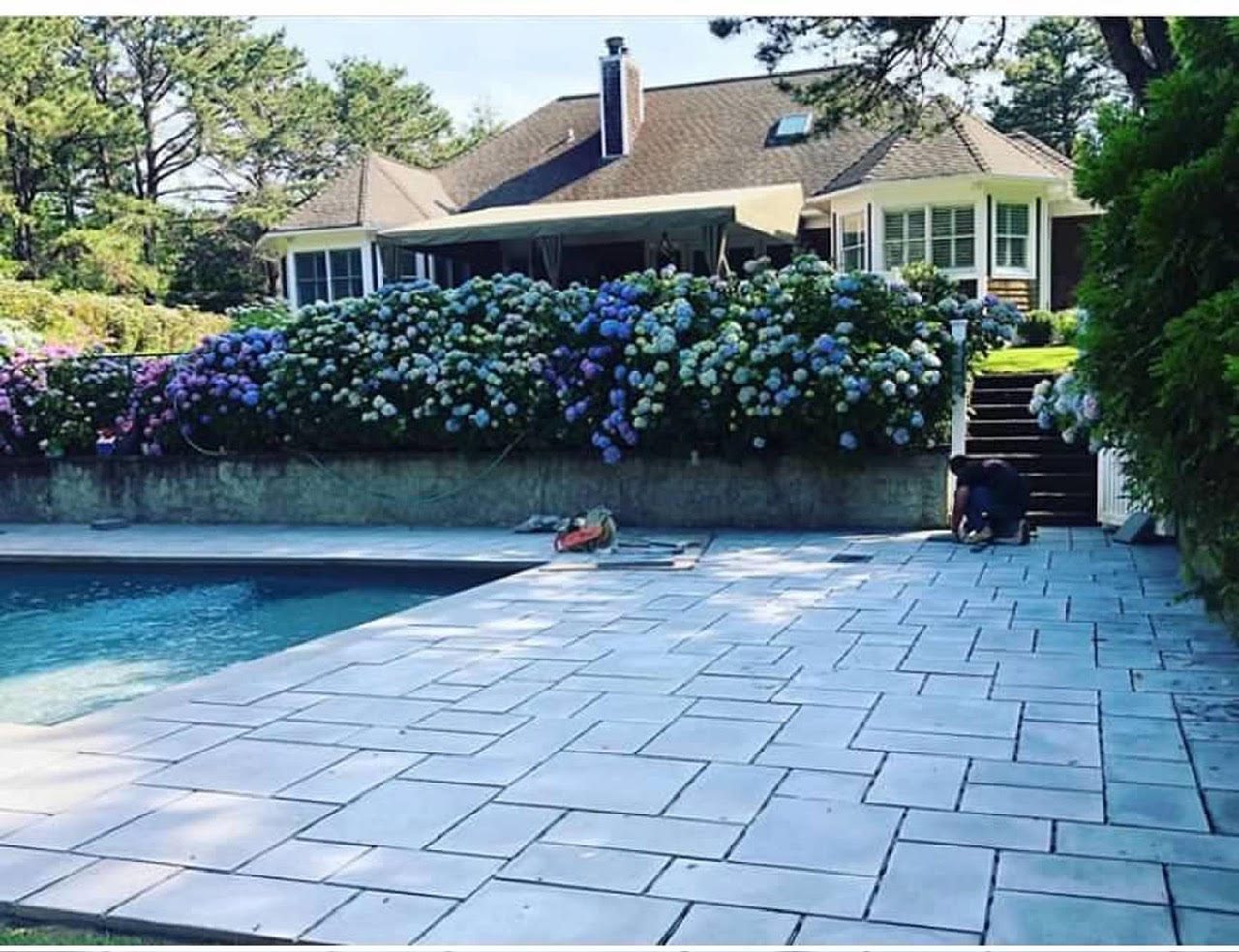 Bluestone-look pool patio with hydrangea border on Long Island