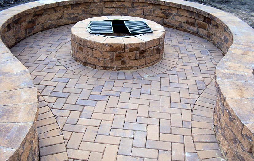Outdoor firepit and grill built into pavers