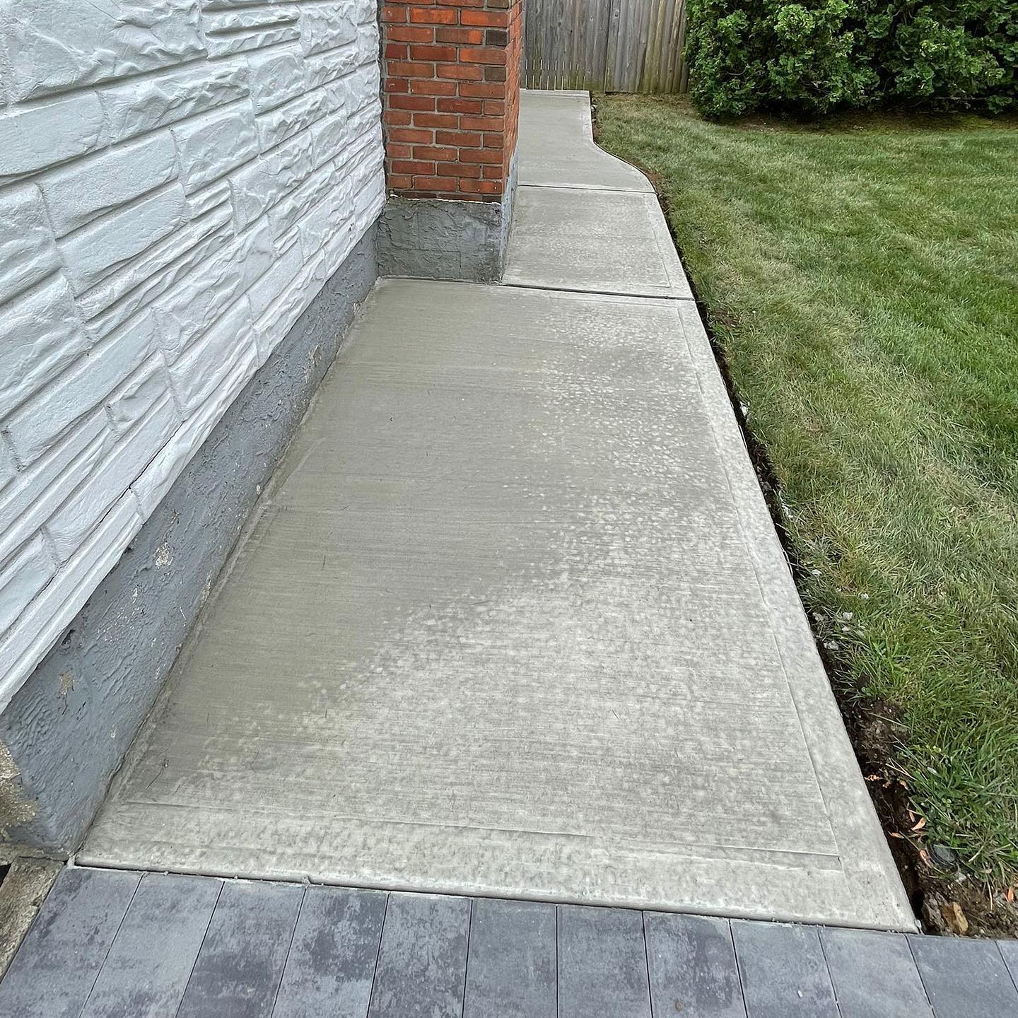 Paver walkway curving through a front yard