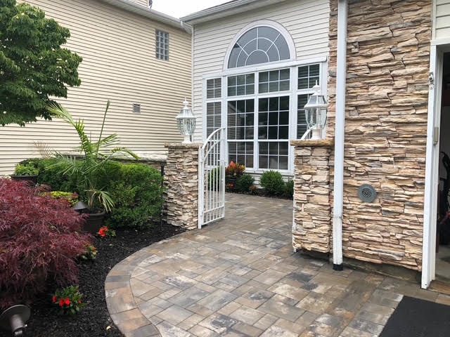 Cultured stone facade with paver walkway and front entry