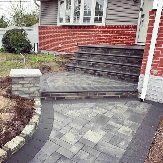 Paver stoop, steps and curved walkway with brick facade
