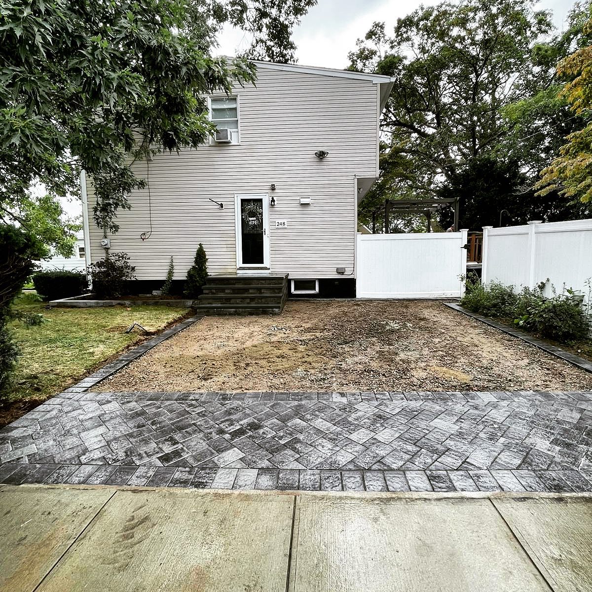 Concrete driveway apron meeting asphalt