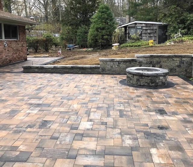 Paver patio with built-in firepit and seating wall